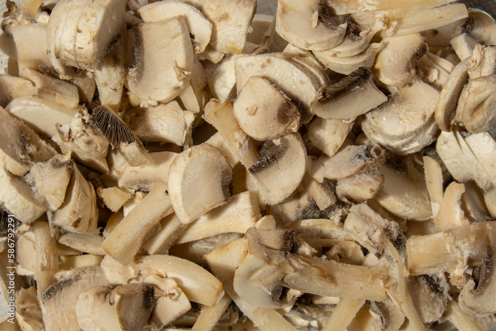 Background made of Frozen food sliced mushrooms champignon homemade. Harvesting concept. Stocking up vegetables for winter storage Healthy food, Cooking ingredients Background made of Frozen food sliced mushrooms champignon homemade. Harvesting concept. Stocking up vegetables for winter storage Healthy food, Cooking ingredients