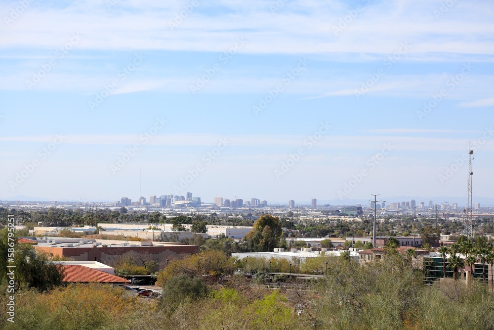 Arizona capital city of Phoenix as seen from a rooftop across south part of Valley of the Sun toward North-East mountains