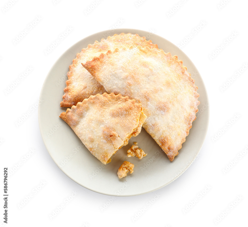 Plate with baked meat empanadas on white background