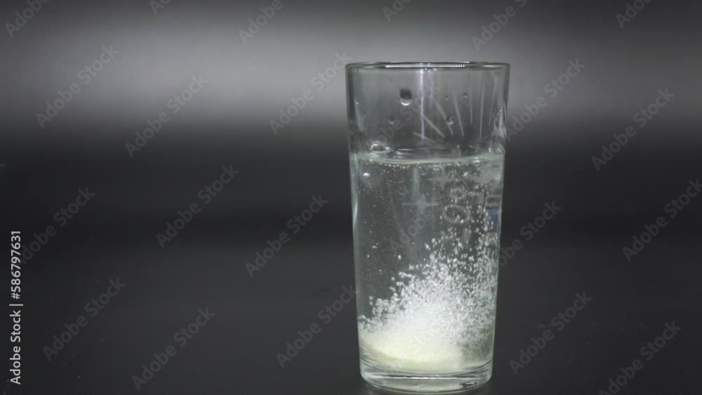 effervescent the tablet is thrown into a transparent glass beaker with water. Vitamin C effervescent the tablet is thrown into a transparent glass beaker with water. Vitamin C