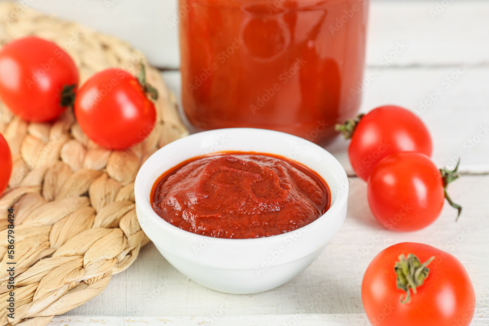 Bowl of tasty tomato paste on white wooden background Bowl of tasty tomato paste on white wooden background