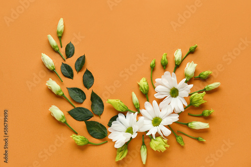 Beautiful composition with white flowers and plant leaves on color background