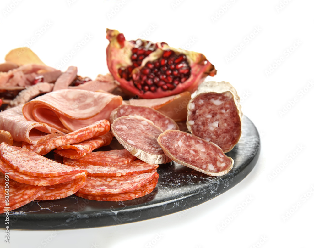 Slate plate with assortment of tasty deli meats isolated on white background, closeup