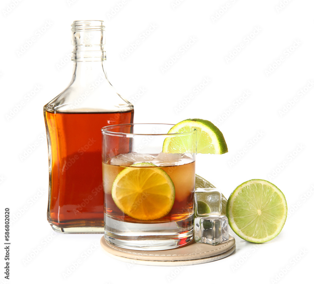 Bottle and glass of cold rum with lime on white background Bottle and glass of cold rum with lime on white background