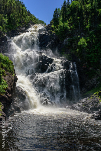 Ouiatchouan Waterfall in the forest of Quebec  Canada  among trees