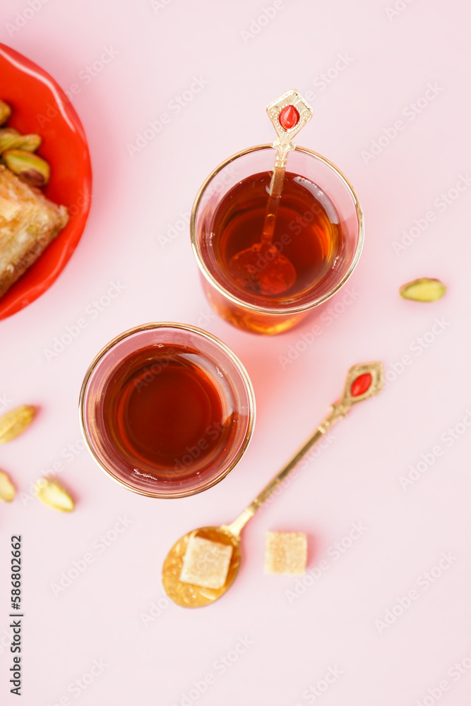 Glass cups of tea with Turkish delight on color background Glass cups of tea with Turkish delight on color background