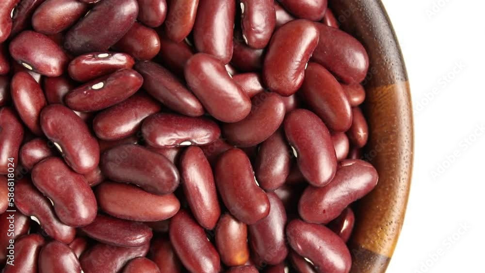 Red kidney beans in wooden bowl rotating on white background, top view.
Red kidney beans in wooden bowl rotating on white background, top view.