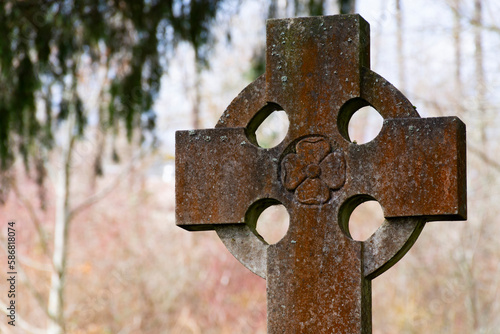 An image of a very old and weather worn tombstone monument. 