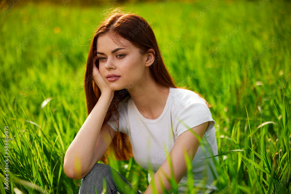 Beautiful young woman close up portrait among green cereal grass Beautiful young woman close up portrait among green cereal grass