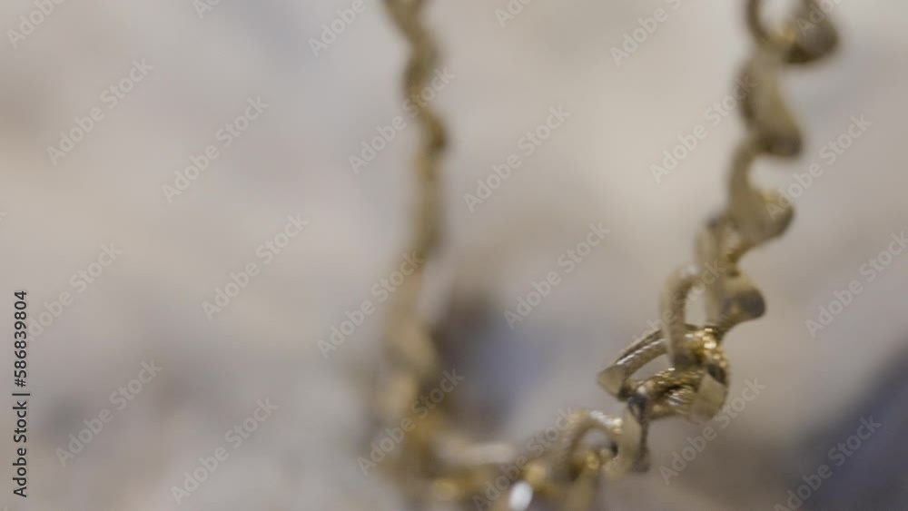 Picking up a Gold chain off of a soft fabric. Picking up a Gold chain off of a soft fabric.