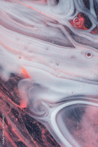 Photo of Beautiful Mixture of White and Red Substances in the Deep Space. Abstract Texture of Expressive Swirls.