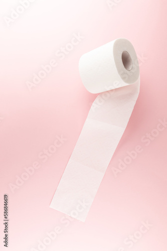 Tissue or toilet paper foroll on pink background with copy space wiping clean. Flat lay and top view image. photo