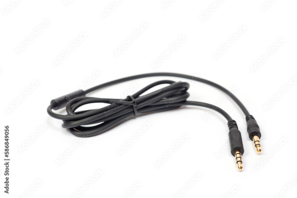 Black cord with a mini jack for connecting various gadgets, shot on a white background. Black cord with a mini jack for connecting various gadgets, shot on a white background.