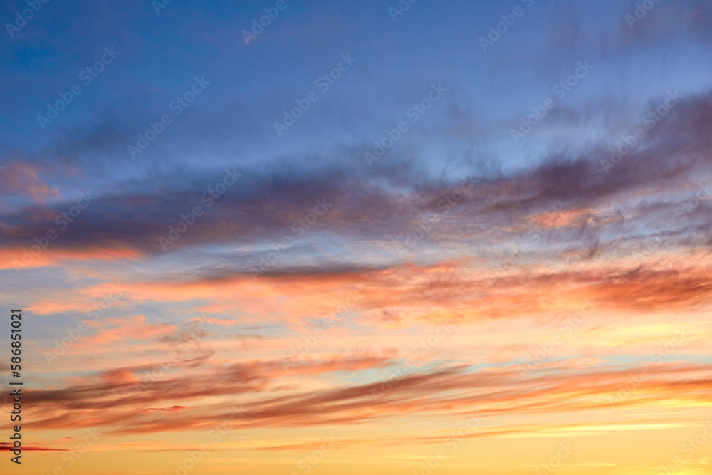 Fototapeta premium Purple, pink and orange tints clouds in the blue sky at sunset. Layered clouds. Scenic wallpaper. Nature background. Colorful space. Evening cloudscape. Peace concept. Heaven paradise. Pure