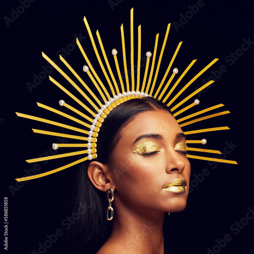 Crown, gold makeup and an elegant queen isolated on a black background in a studio. Dreaming. art and an Indian goddess with cosmetics, accessories and jewelry for royalty on a dark backdrop