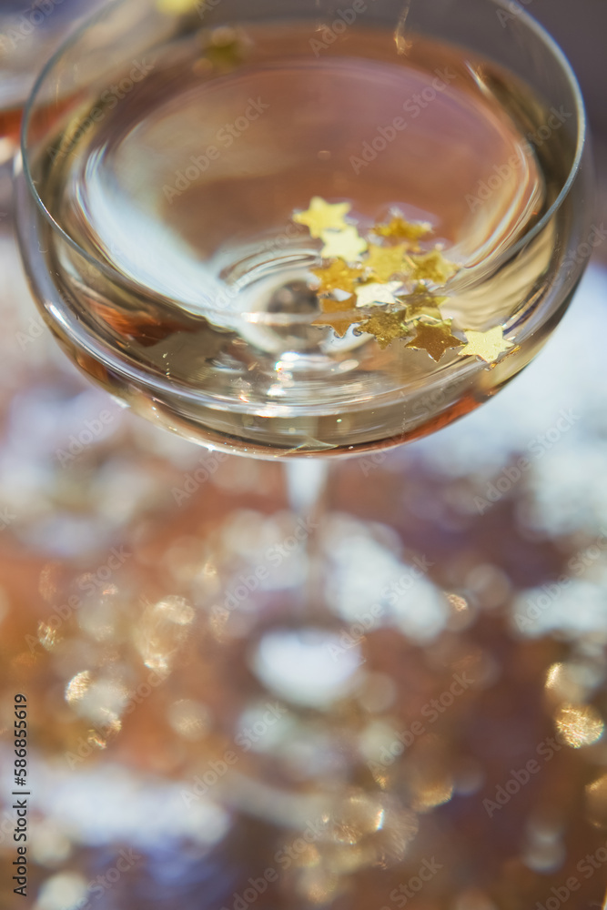 Glass of champagne with golden stars Glass of champagne with golden stars