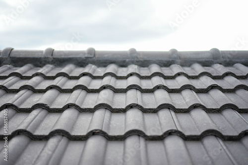 concept for house roof icon with gray tiled banner texture for roof gray tile background