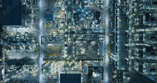 Aerial view of oil and gas petrochemical industrial with Refinery factory. industrial area buildings scenery at night. High Angle view.