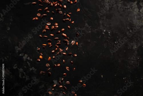 Roasted coffee beans falling on black background, Concept for coffee product advertising, Selective focus, place for text