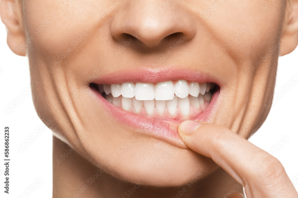 Woman showing healthy gums on white background, closeup Woman showing healthy gums on white background, closeup