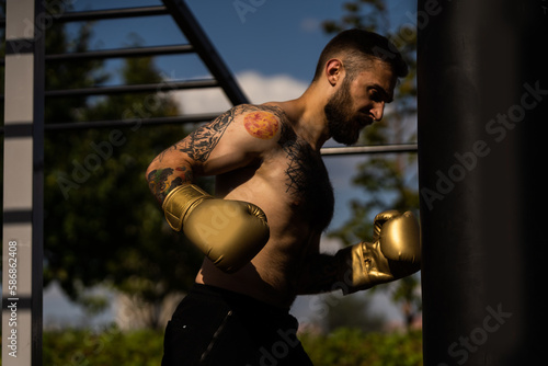 Part of man wearing boxing gloves.