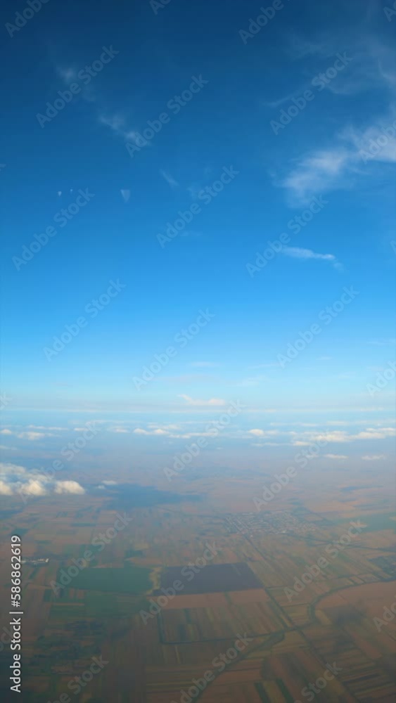 Aerial shot of cultivated plain landscape of Vojvodina in Serbia, high angle view from airplane, vertical footage Aerial shot of cultivated plain landscape of Vojvodina in Serbia, high angle view from airplane, vertical footage