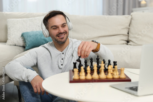 Teacher near chessboard conducting online lesson at home. Time for hobby