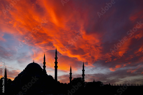 Silhouette of Suleymaniye Mosque and dramatic clouds at sunset.