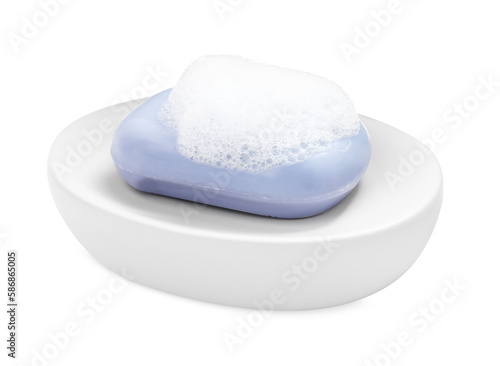 Soap bar with fluffy foam in holder on white background