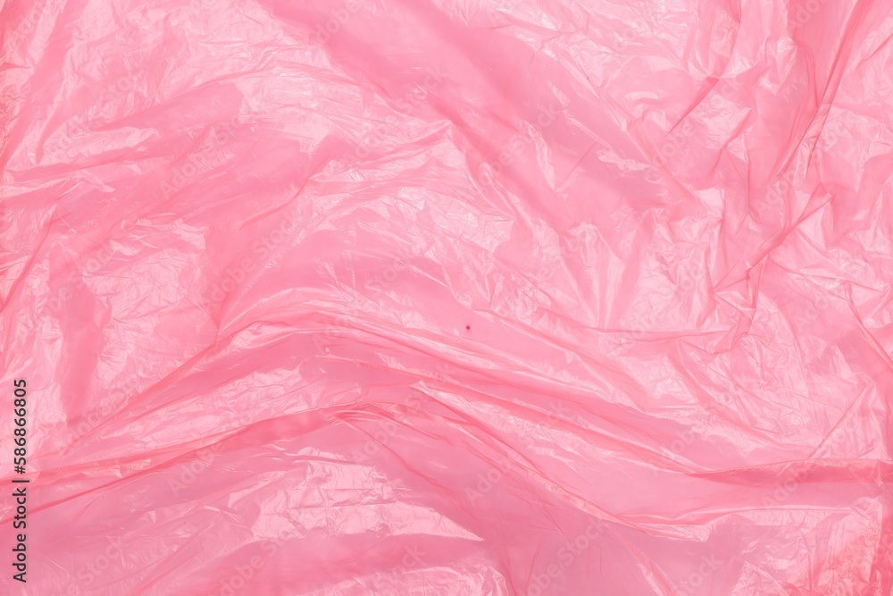Crumpled pink plastic bag as background, top view Crumpled pink plastic bag as background, top view