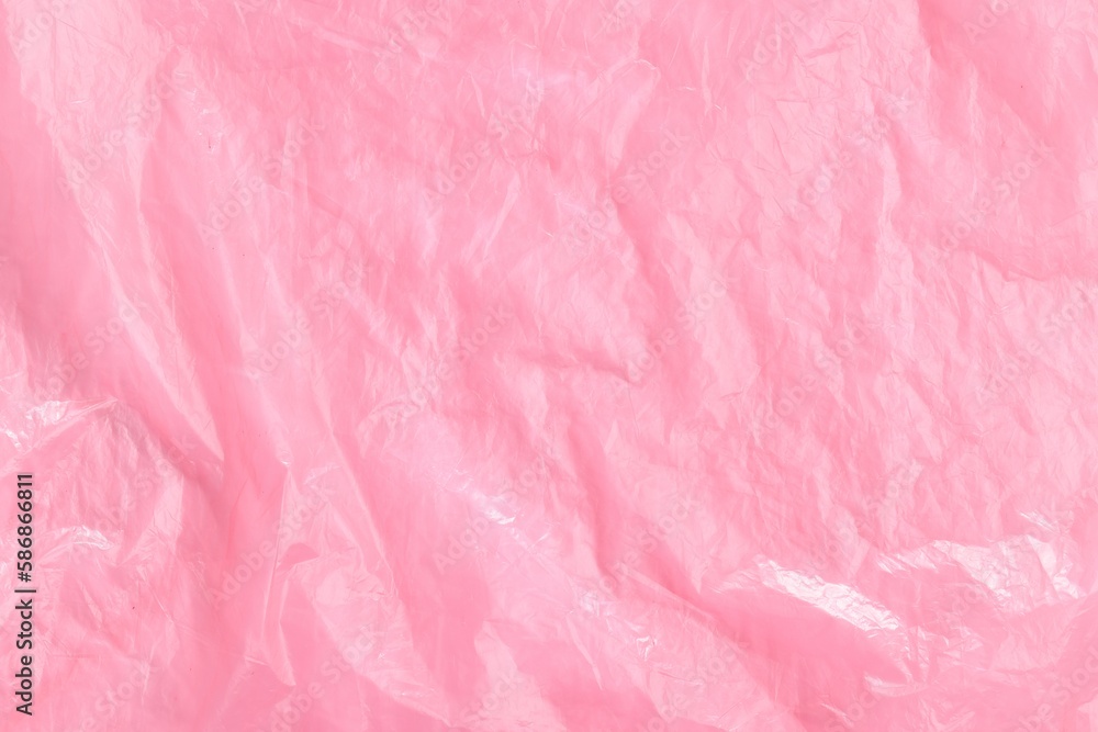 Crumpled pink plastic bag as background, top view Crumpled pink plastic bag as background, top view