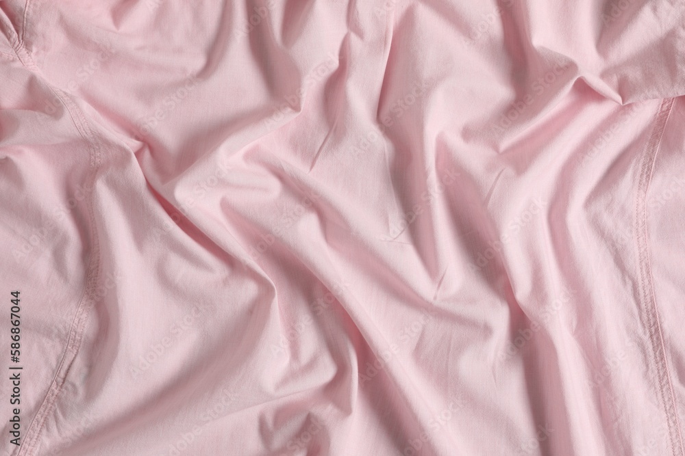 Crumpled pink fabric as background, top view Crumpled pink fabric as background, top view