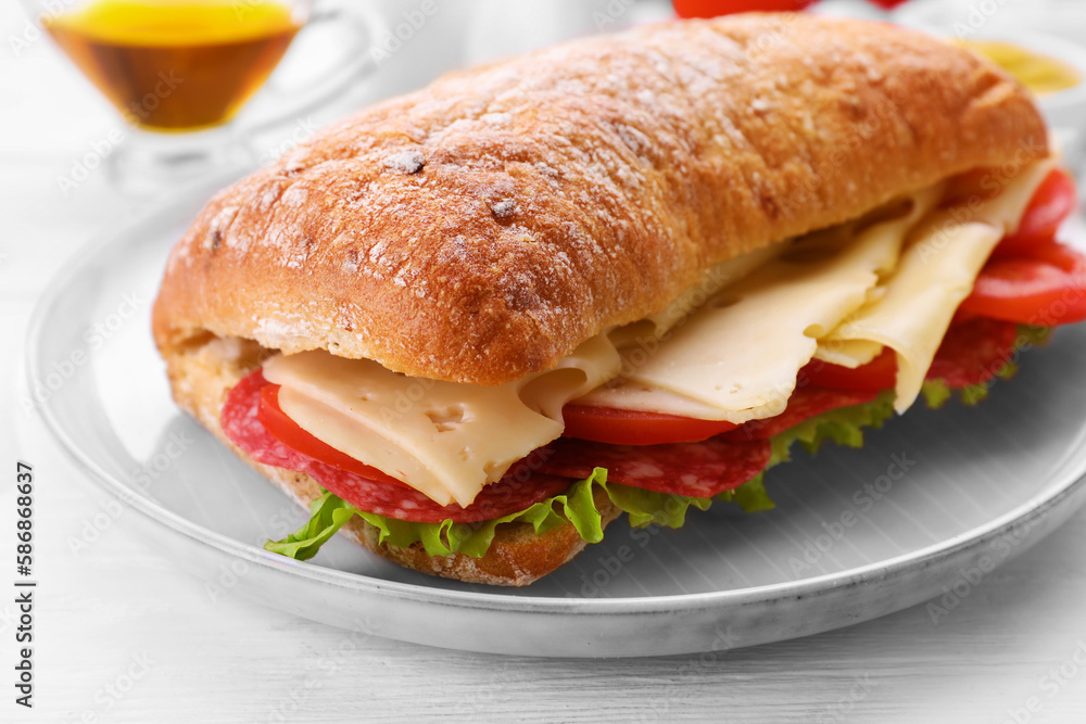 Delicious sandwich with cheese, salami, tomato on white wooden table, closeup Delicious sandwich with cheese, salami, tomato on white wooden table, closeup