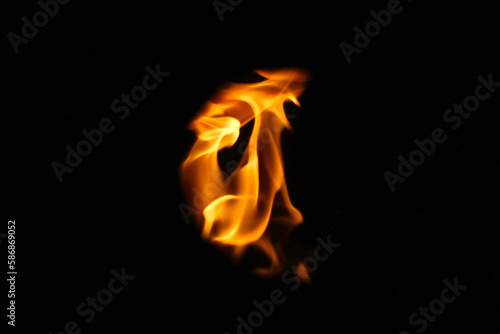 Demon fire flames. Eagle silhouette Fire embers particles over black background. Fire sparks background. Abstract dark glitter fire particles lights. bonfire in motion blur. Out of focus © tanitost