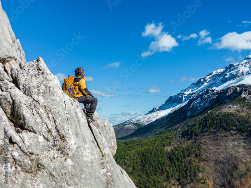 mountaineer man watching mountains views from cliff on cliffs