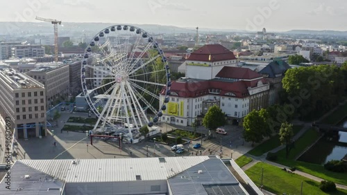Ferris wheel in the city of Dresden. Drone move forward