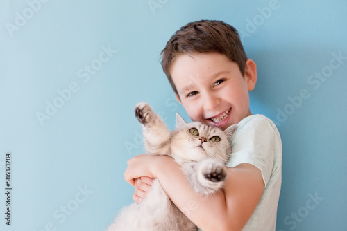 Child and cat on blue background