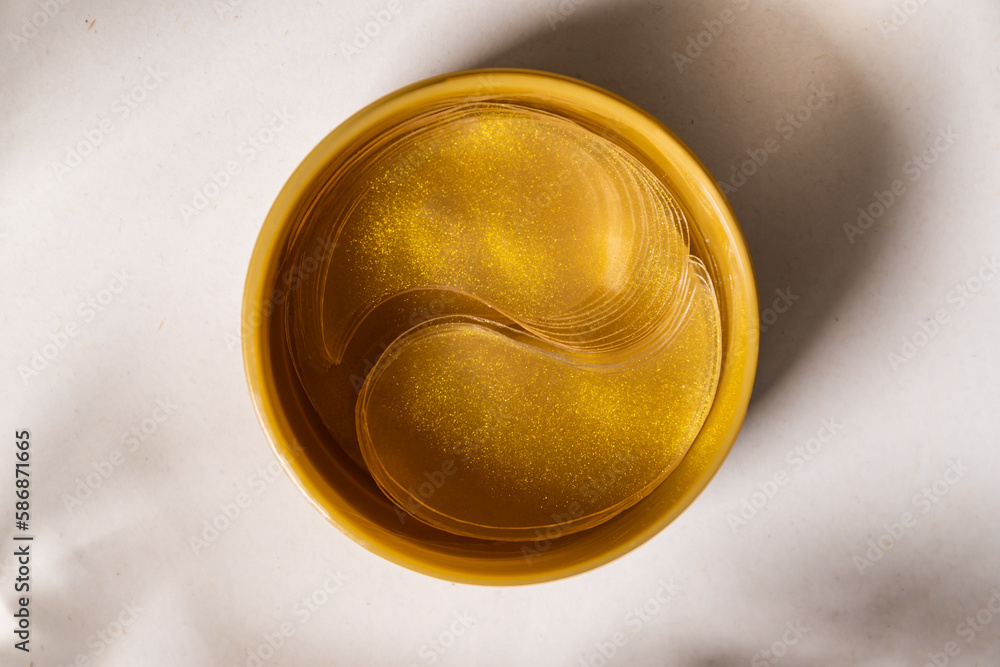 Gold moisturizing eye patches in a package.Top view. Gold moisturizing eye patches in a package.Top view.