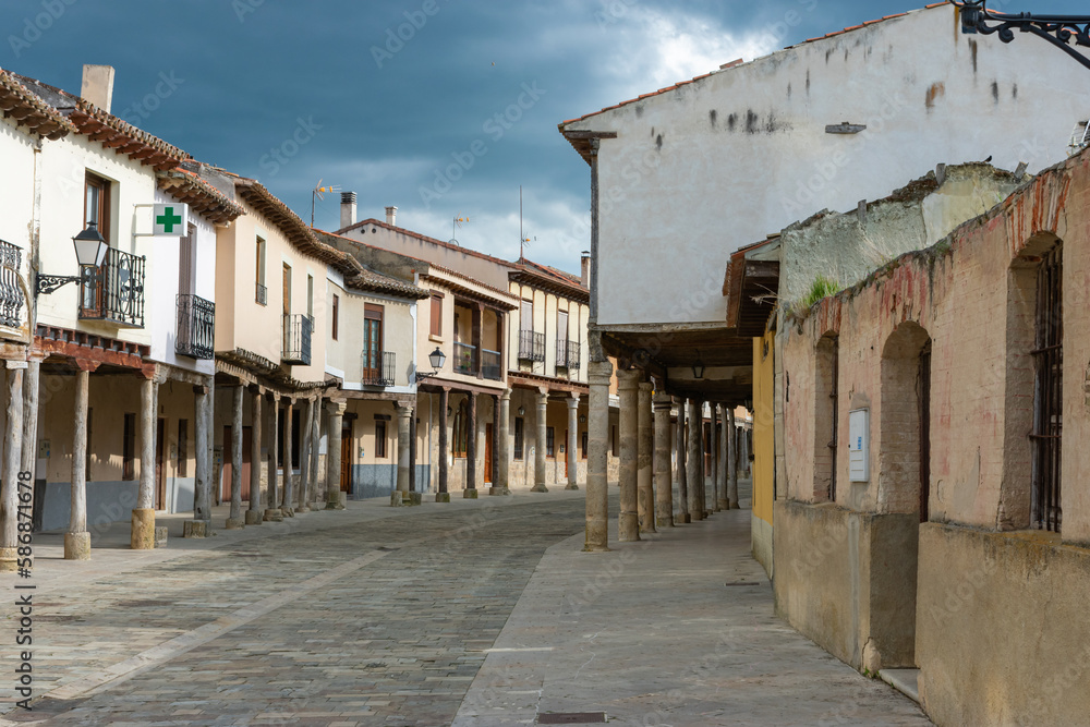medieval village street with cobblestones and porticoes