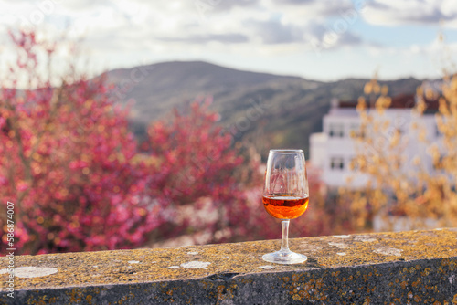 Wallpaper Mural A glass of orange beverage moscatel wine - traditional Portuguese alcoholic drink, mountains view   Torontodigital.ca