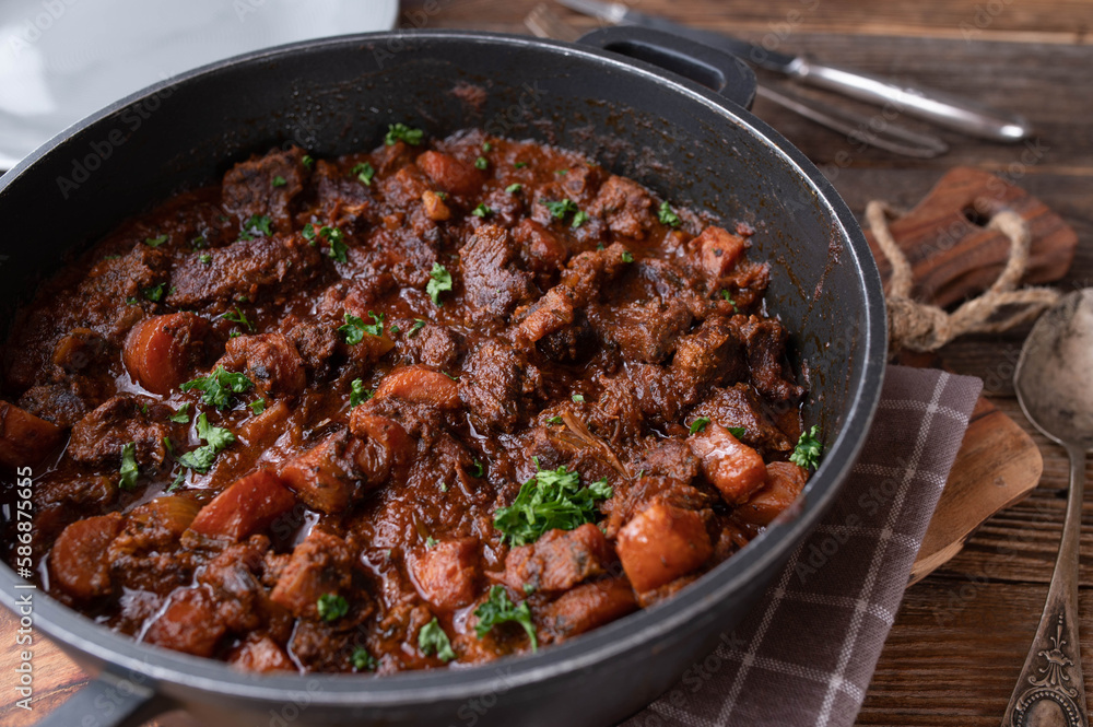 Braised pork with carrots and brown sauce in a pot Braised pork with carrots and brown sauce in a pot
