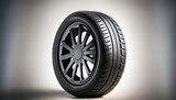 A car tyre against a neutral background. Space for text. Change car tyre. 