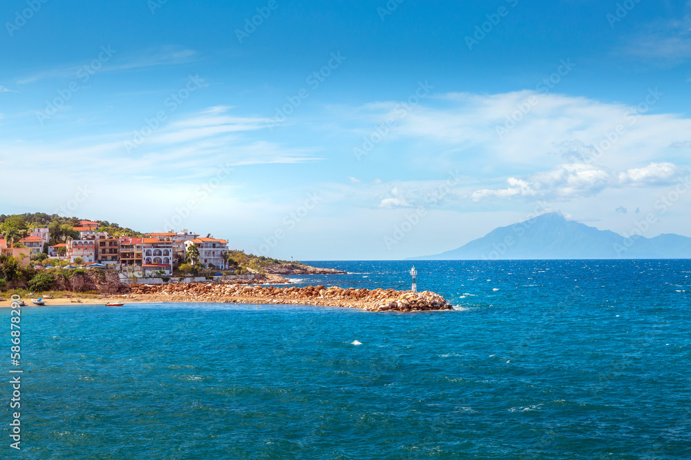 Panorama of town and sea coast line in Thassos Island, Greece. Mount Athos on background