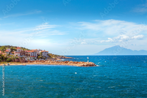 Fototapeta Naklejka Na Ścianę i Meble -  Panorama of town and sea coast line in Thassos Island, Greece. Mount Athos on background