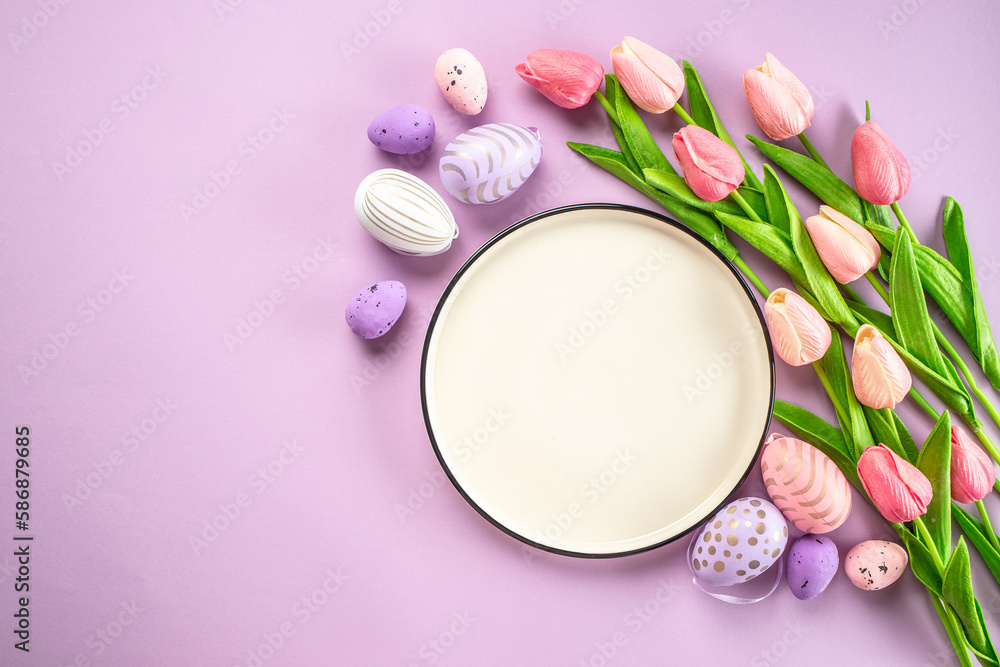 Easter eggs with white plate and spring flowers. Easter background