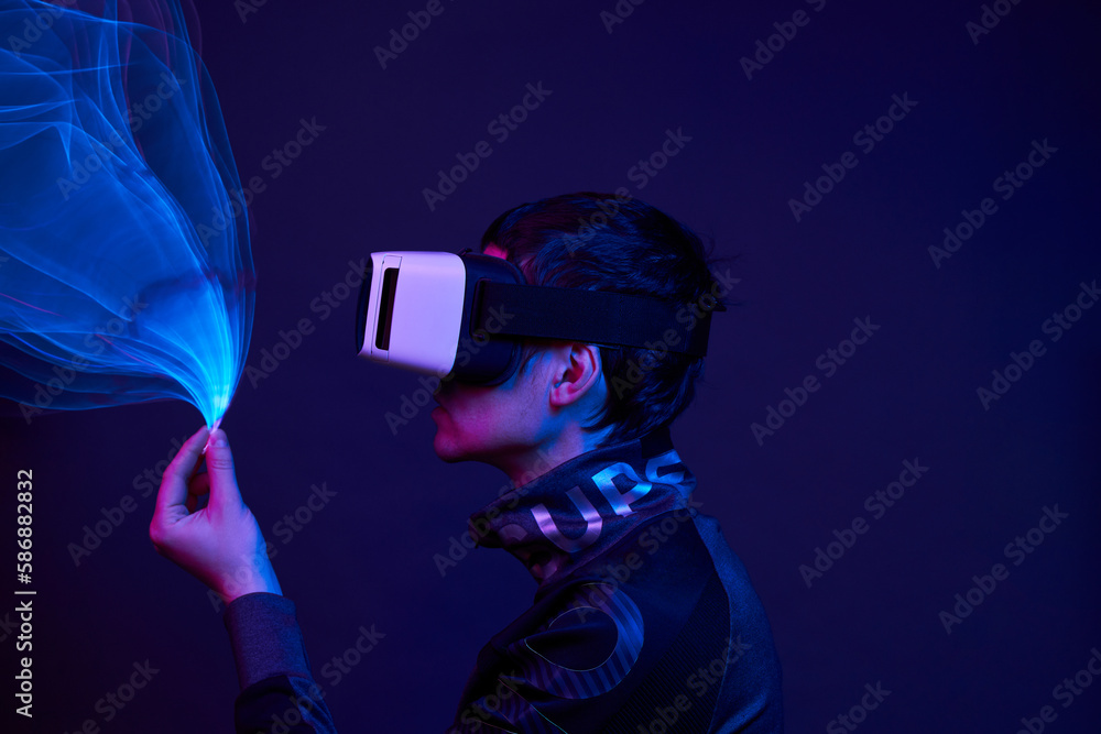 Man is using virtual reality headset to access in metaverse.