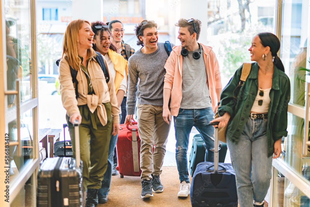 Group of university college tourist walking inside the hotel with suitcases -Young happy students enjoying summer holiday-Tourism Vacation and Lifestyle concept with people-Youth culture-Spring time  - obrazy, fototapety, plakaty 