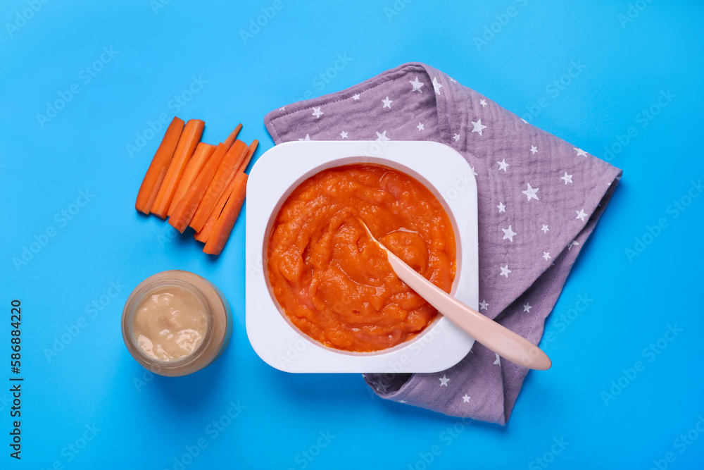 Healthy baby food and carrot on light blue background, flat lay Healthy baby food and carrot on light blue background, flat lay