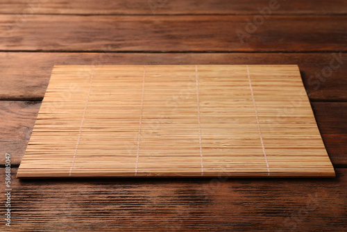 Bamboo mat on wooden table  space for text