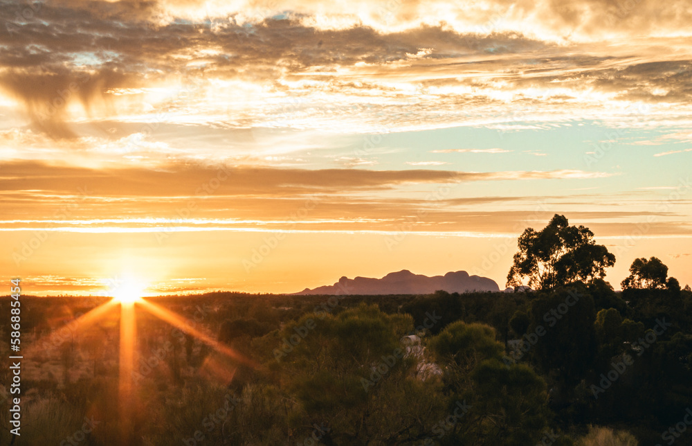 Gorges sunset scene of Kata Tjuta under the beautiful sky and clouds from afar 